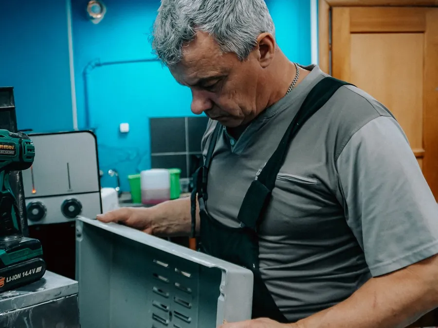 Repair Technician Working on Appliance