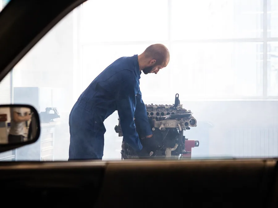 A Mechanic Working on an Engine