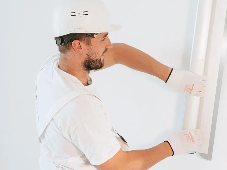 A Man Fixing the Wall