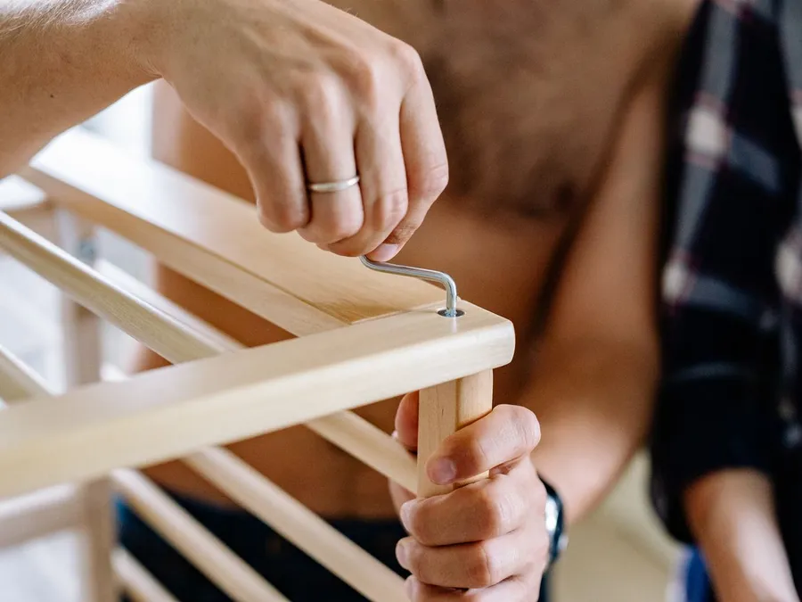 Close-up of Married Man Assembling Furniture