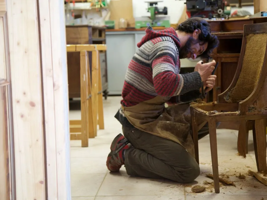 Craftsman Restoring Antique Wooden Chair