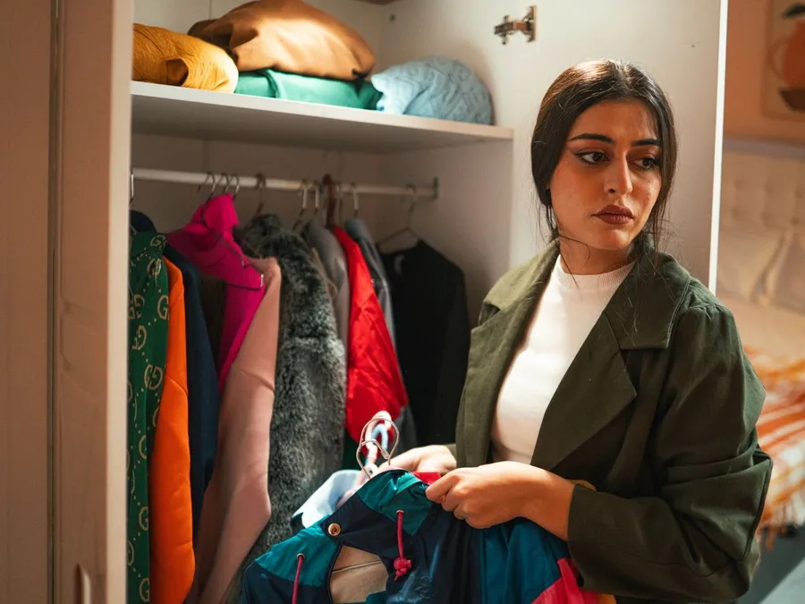 Woman Organizing Wardrobe in Bedroom