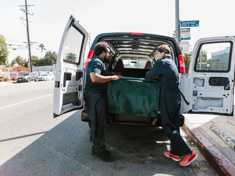 Men Putting the Green Velvet Box at the Back of the Van