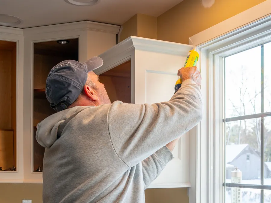 Home Renovation: Caulking a Kitchen Cabinet