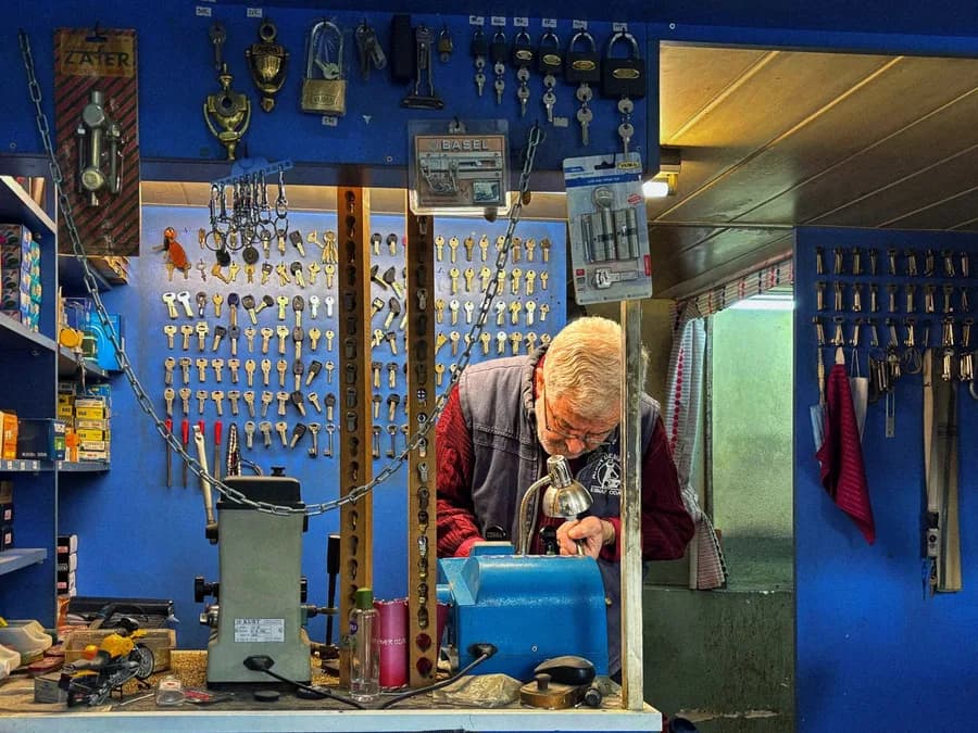 Elderly Locksmith Working in Key Shop