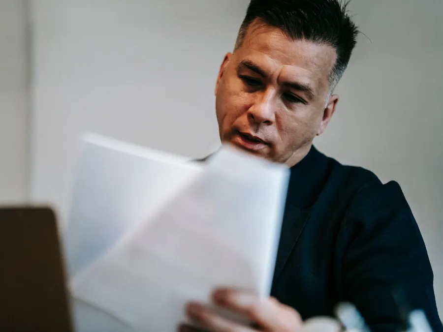 Photo Of Man Reviewing The Documents