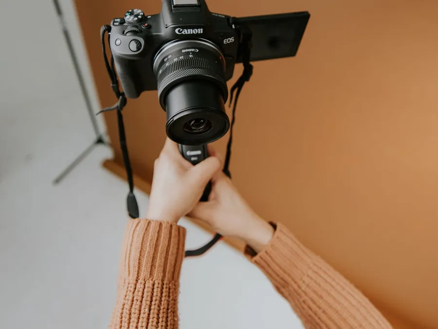 Photographer Holding Camera in Studio Setting