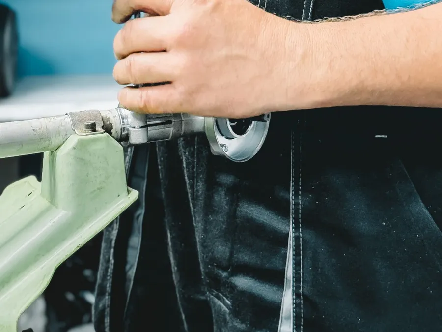 A plumber repairing a pipe with a wrench