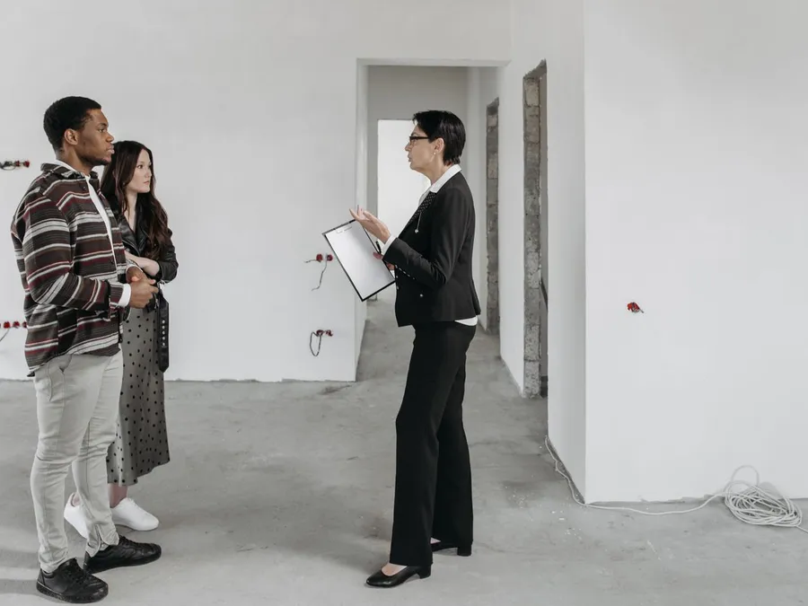 Seller Speaking to Clients in House Room