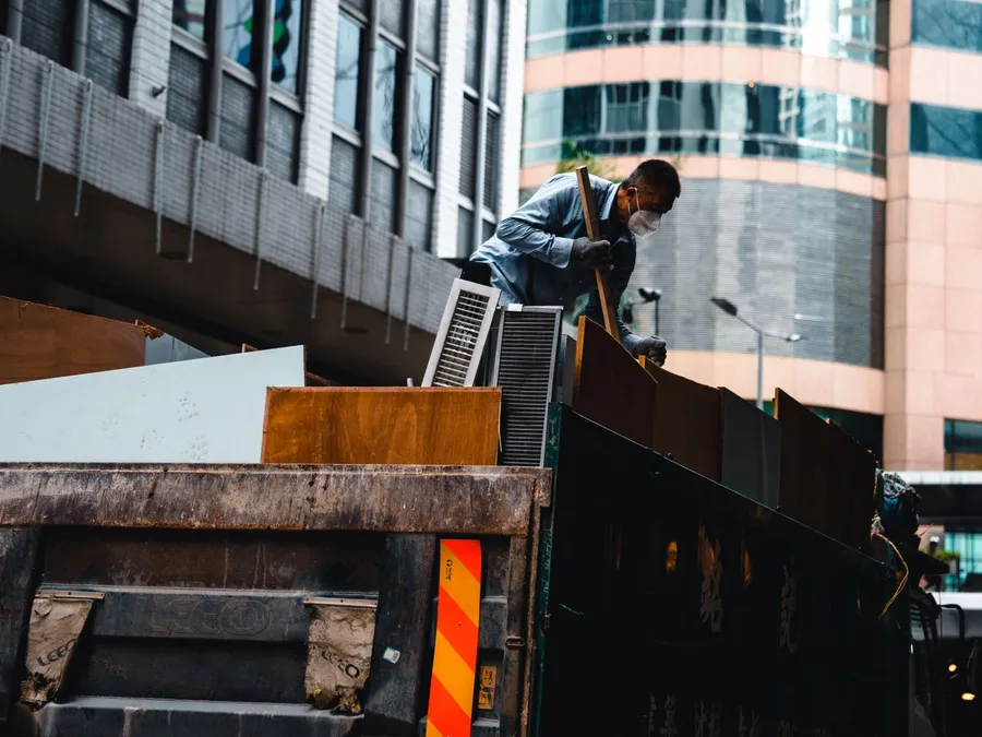 Cleaner in Mask Standing and Working on Truck