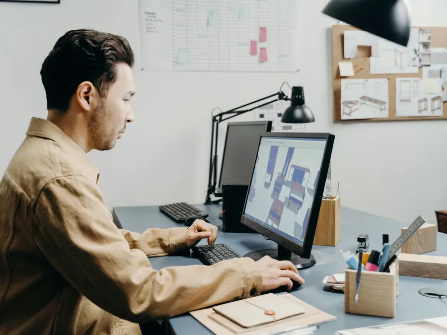 A Man in Brown Long Sleeves Using Computer