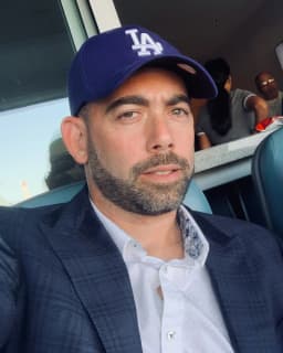 Kilay Reinfeld, founder of Conservus, wearing a blue LA cap and blazer
